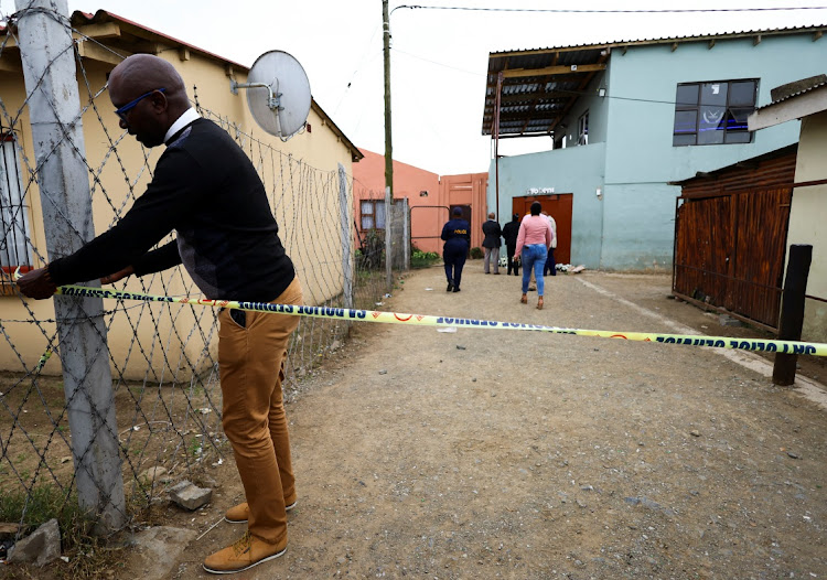 A police officer cordons off Enyobeni, an east coast tavern where bodies of youth were found which prompted nationwide grief, ahead of a mass funeral in the Eastern Cape province, in East London.