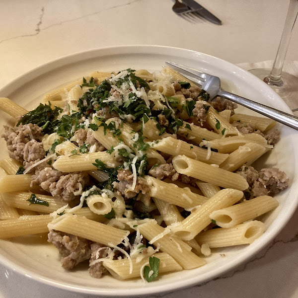 GF pasta with sausage, spinach and kale in garlic butter sauce