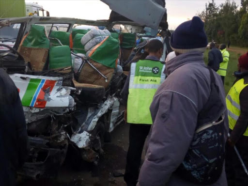 Rescuers examine the wrecked matatu which was involved in an accident at Salgaa on Wednesday, August 10. /AMOS KERICH