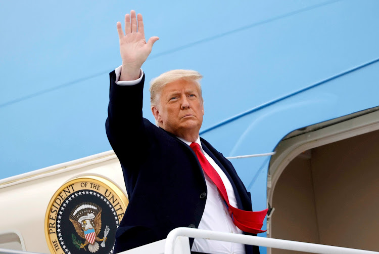 FILE PHOTO: U.S. President Donald Trump salutes as he boards Air Force One at after visiting the U.S.-Mexico border wall, in Harlingen, Texas, U.S., January 12, 2021. REUTERS/Carlos Barria