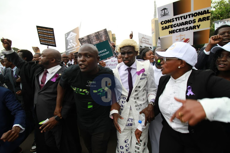 Lawyers carrying banners along City Hall Way, Nairobi against President William Ruto's utternances against the Judiciary on January 12, 2024