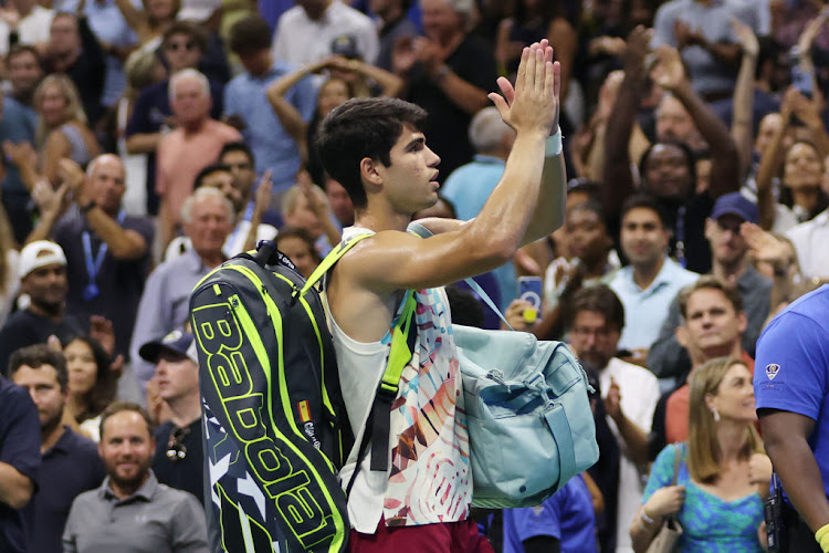 Carlos Alcaraz of Spain waves to the crowd after he was defeated by Daniil Medvedev of Russia in their men's singles semifinal of the 2023 US Open at the USTA Billie Jean King National Tennis Center.