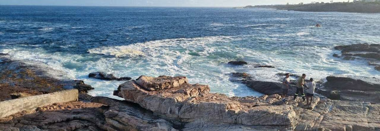 The men, believed to be from Zimbabwe, were swept off the rocks by waves.