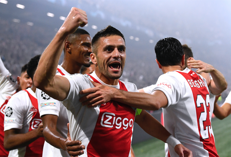 Ajax Amsterdam's Dusan Tadic celebrates with teammates during a Champions League match against Borussia Dortmund