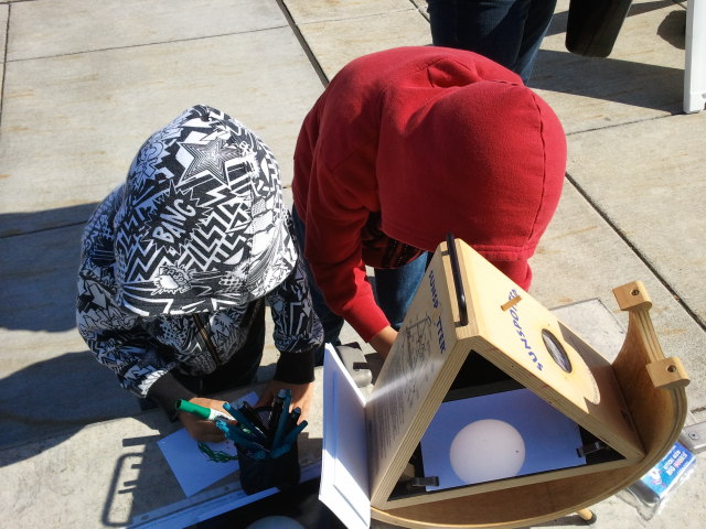 Two young scientists watching the transit of Venus (2012)