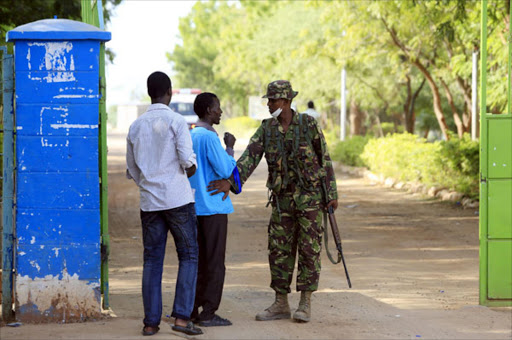 A Kenyan Defense Force soldier guards the main entrance of Garissa University College following an attack by the Al Shabaab on Thursday, that left at least 147 people dead and 79 injured. Photo/REUTERS