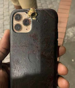 Mqadi's iPhone 12 with shrapnel from a bullet as a result of the attempted assassination on his life on Thursday