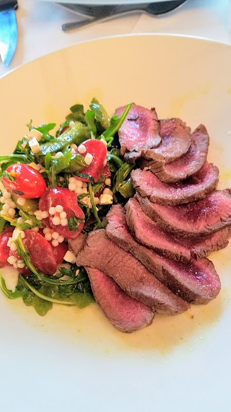 Jake's Grill and Anderson Ranches Lamb Pasture to Plate specials menu: coriander seared lamb loin salad with arugula, toy box tomatoes, cous-cous, charred red onion, feta, and lemon-cilantro vinaigrette. Note: this was a shared salad for 5 people so they added more lamb then probably an individual plate would have, but still gives you an idea of the dish 