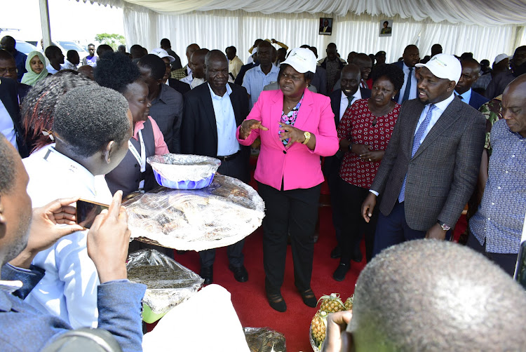 Homa Bay Governor Gladys Wanga with Roads CS Roads Kipchumba Murkomen receive fish and other gifts at Kabunde Airstrip in Homa Bay town on June 12