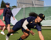 Chloé Tryon takes a catch during practice as Lizelle Lee enjoys a light moment behind her. 