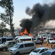 Cars were burned in a parking lot at the Cedar Junction Family Resort in Pretoria.