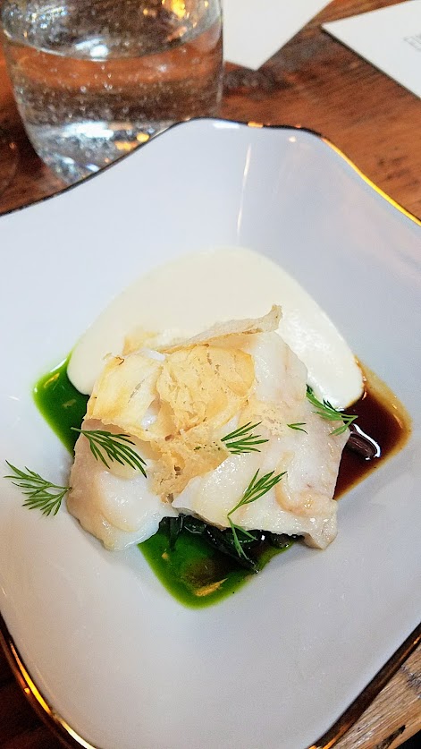 Fimbul Icelandic Dinner Spring 2018, Cod with dandelion, birch, potato - the cod is poached and also in chip form and the sauces are the dandelion greens and birch syrup below with potato foam.