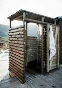 Enclosed in a wooden shell, the outdoor shower is a refreshing all-weather treat.