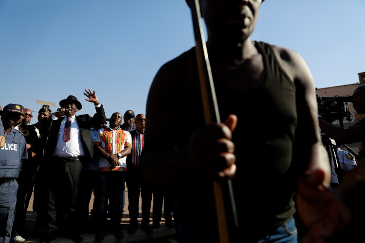 Police minister Bheki Cele addresses residents in Jeppestown, Johannesburg, on Tuesday in the wake of five deaths and close to 170 arrests in ongoing violence across Gauteng.