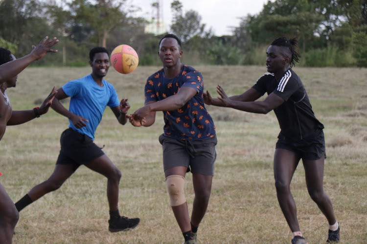 USIU-Africa captain Elvis Kadima (C) leads teammates during a training session