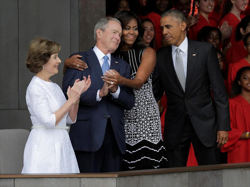 The Obama and Bush families sat side-by-side at they took seats of honor at the opening ceremony./DAILY MAIL