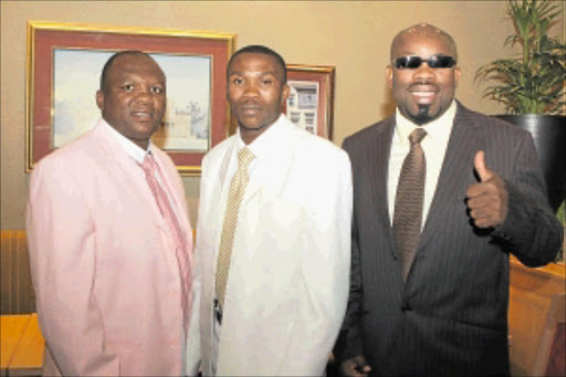 TOUGH TRIO: Paulos 'Hitman' Moses, WBA lightweight world champion from Namibia, flanked by former ring greats Dingaan Thobela, left, and Nestor Tobias. Photo: Bafana Mahlangu