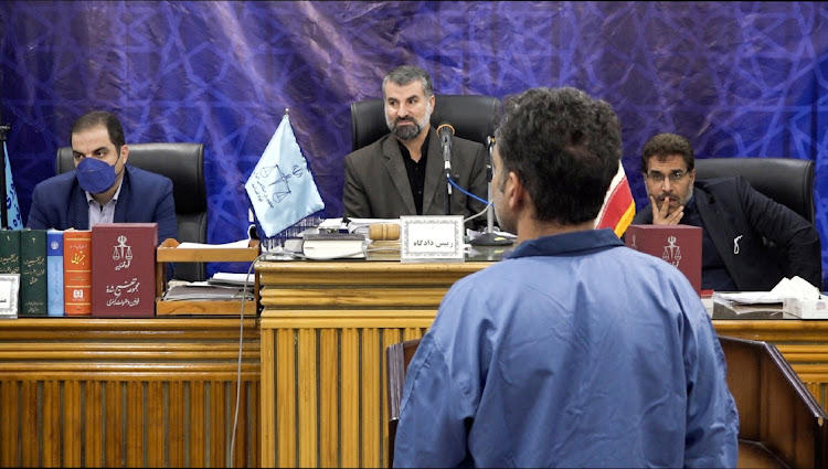 A judge sits in front of Saeid Yaghoubi, who is to be executed by hanging along with Majid Kazemi, in Isfahan, Iran. Picture: WANA NEWS AGENCY/MIZAN NEWS AGENCY/REUTERS