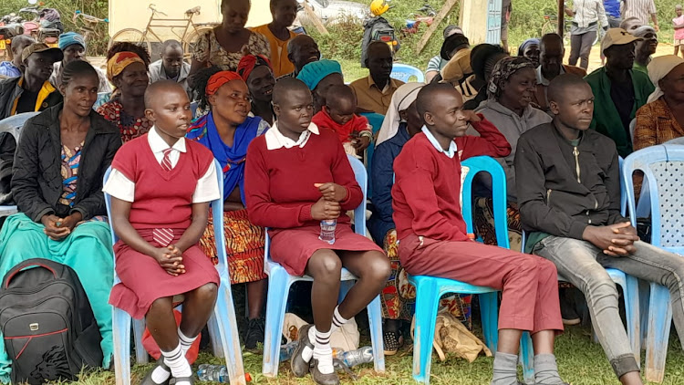 Some of the students who received cheques through sponsorship organised through Kisumu City manager Abala at Wagai Resource Centre in Gem Constituency on Thursday