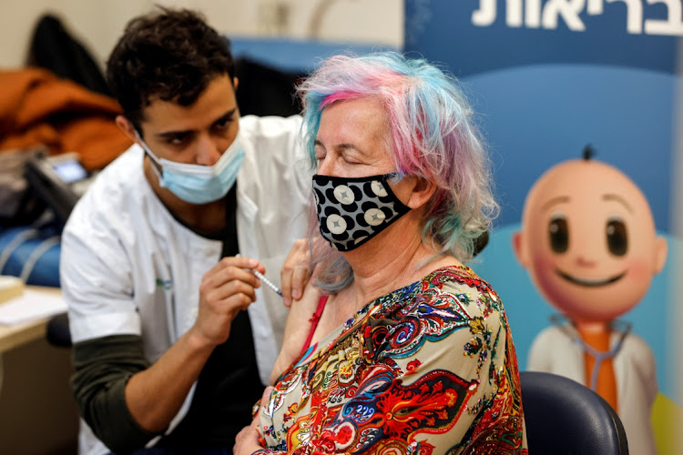 A woman receives the fourth dose of the Covid-19 vaccine after Israel approved a second booster shot for the immunocompromised, people over 60 years and medical staff, in Tel Aviv, Israel January 3 2022. Picture: REUTERS/AMIR COHEN