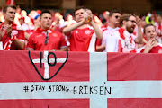 A 'stay strong' message of support for Christian Eriksen, who collaped in the match against Finland, is displayed on a flag by Denmark supporters prior to their team's Euro 2020 group match against Belgium at Parken Stadium in Copenhagen on June 17 2021.