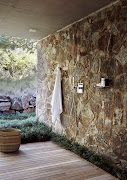 Downstairs, the shower is a semi-outdoor design, open to the dolomite retaining wall down one side of the koppie. 