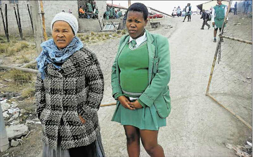 AT HAND: Nomavoti Nontuma, 53, of Mthwaku village, leaves Flagstaff Comprehensive School on Friday with her 19-year-old daughter Masonwabe Nontuma, who is six months pregnant Picture: SIKHO NTSHOBANE