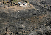 Homes lost to blazes in Knysna are surrounded by scorched land. File photo.