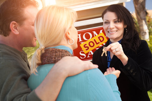 Realtor+Couple Giving Keys