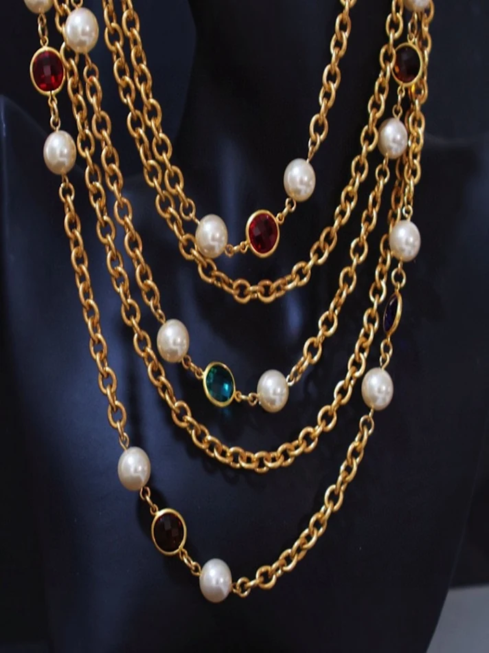 Collier vintage multi-rangs avec perles et pompons. Accessoire parfait pour un look rétro et élégant, idéal pour toutes les occasions.