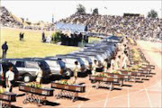 The mas funeral of 84 miners who died in the Vaal Reefs gold mine disaster was held in Orkney. © Unknown.