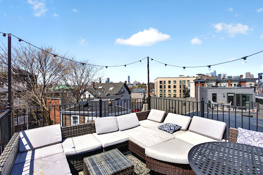Property purchase in Boston (United States) - rooftop terrace with outdoor furniture and city view
