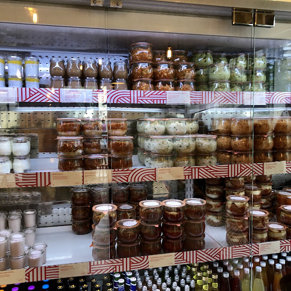 The foods are in this refrigerator in glass containers. You pick what you want and bring it to the counter. The items that require heating will be heated at the counter and the bread is in a basket.
