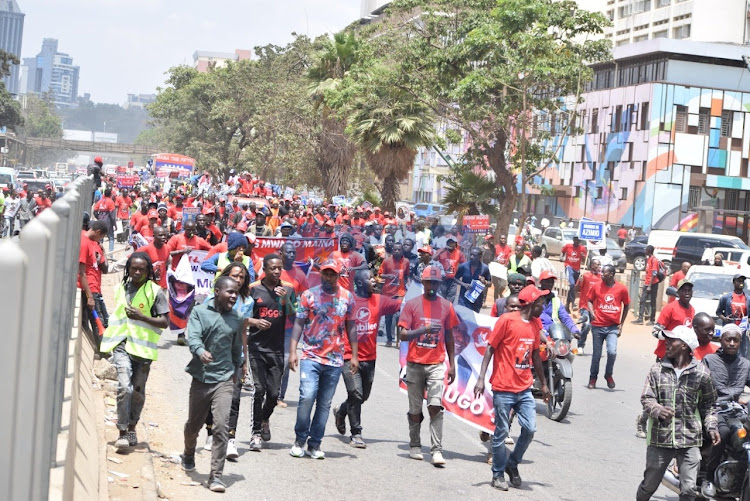 Azimio la umoja supporters display placards of Jubilee Starehe Contituency candidate Amos Mwago along Uhuru Highway on March 18, 2022