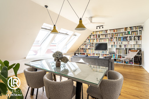 Buy this luxury property in Puteaux (92800) - Neighborhood Centre Ville-Vieux Puteaux - Living room with wall library and dining area