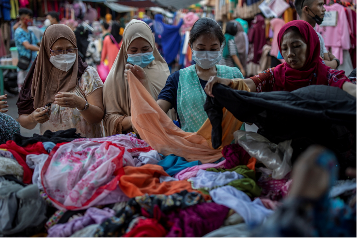 Filipino Muslims shop at a street market ahead of the Eid al-Fitr festival marking the end of the Islamic holy month of Ramadan, amid the coronavirus disease outbreak in Quiapo, Manila, Philippines, on May 12 2021.