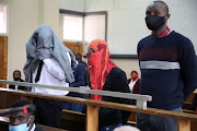 Simon Scorpion Ndyalvane, Caylene Whiteboy and Forster Netshiongolo appearing in the Protea magistrate’s court in Soweto during their earlier appearance.