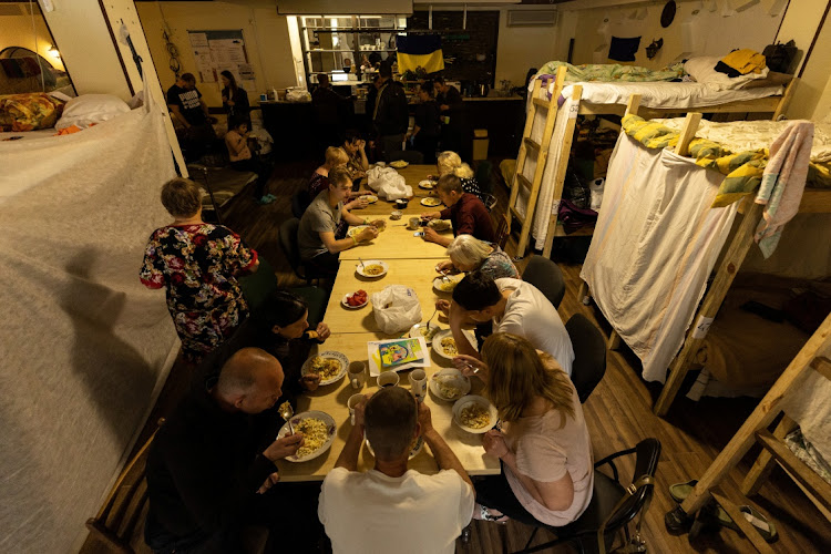 Internally displaced people from the Donbas region have a meal provided by the NGO World Central Kitchen, in a shelter organized in a former coffee shop, amid Russia's invasion of Ukraine, in Dnipro, Ukraine May 14, 2022.