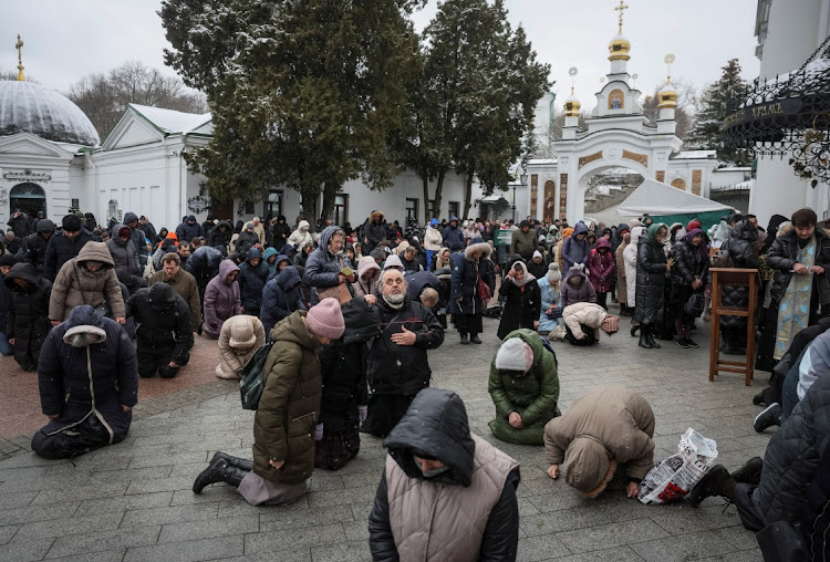 Believers pray outside a church during a service led by Metropolitan Onufriy, head of the Ukrainian Orthodox Church, accused of being linked to Moscow, in the compound of the Kyiv Pechersk Lavra monastery, amid Russia's attack on Ukraine, in Kyiv, Ukraine March 29, 2023. Picture: REUTERS/Gleb Garanich