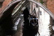 A gondola is seen in a canal during a severe low tide in the lagoon city of Venice, Italy, March 17, 2022. 