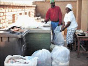 HELPING HANDS: Solomon and Valeria Modabi with the bags of clothes and shoes. © Sowetan.