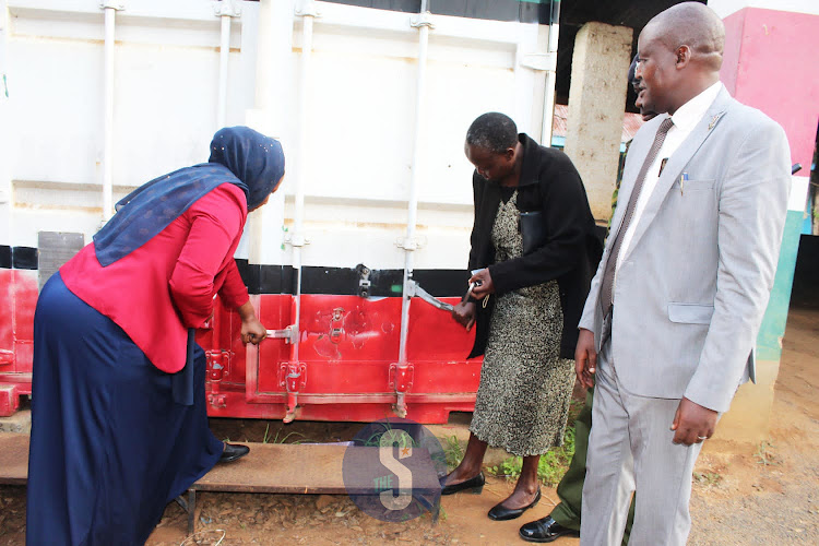 Kitui Central subcounty education director Mary Shano, subcounty deputy commissioner Dorcas Runo, subcounty police boss Crispus Ogutu and Education director John Thirigi during the opening of the KCSE exam container at the deputy county commission’s office on Friday, December 2.