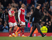  Arsenal manager Mikel Arteta walks off the pitch looking dejected followed by Leandro Trossard and Gabriel Magalhaes after the 4-1 defeat to Manchester City at Etihad Stadium on April 26, 2023 in Manchester, United Kingdom.