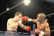 NOBODY'S CANNON FODDER:   Grant Fourie and Koos Sibiya    during their lightweight fight  at Emperors Palace in Ekurhuleni. PHOTO: ANTONIO MUCHAVE