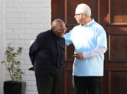 Archbishop Emeritus Desmond Tutu, with IEC area manager Allan du Plooy, at home where he cast his vote in Cape Town on May 6 2019. 