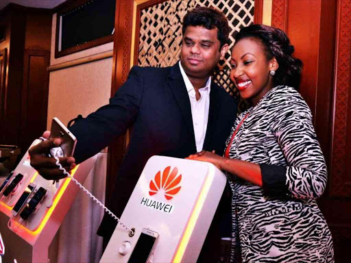 Dharmaraj Diwakar (left) Huawei Sales Director takes a selfie with Mwalimu Rachel of Homeboyz Radio during the launch of four new Huawei phones at Serena Hotel on 1st September. Photo/FILE