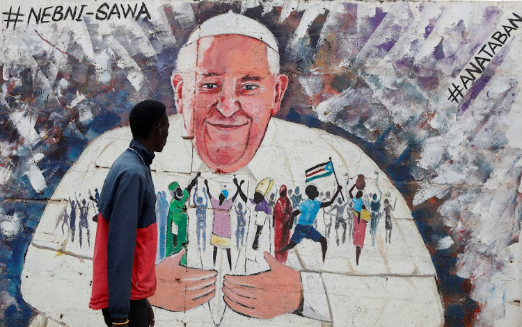 A man looks at a wall mural depicting Pope Francis as preparations to welcome the Pope continue, in Juba, South Sudan February 1, 2023.