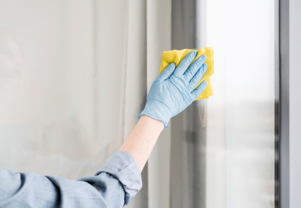 wiping-windows-using-cleaning-cloth-with-disinfectant 