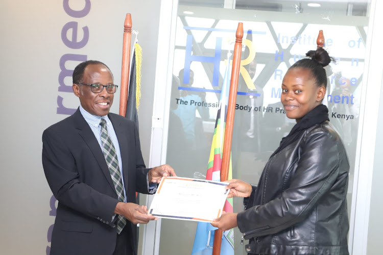 Mathangani Muya being presented with election certificate after being elected IHRM Council member for Nairobi and Northeastern region.