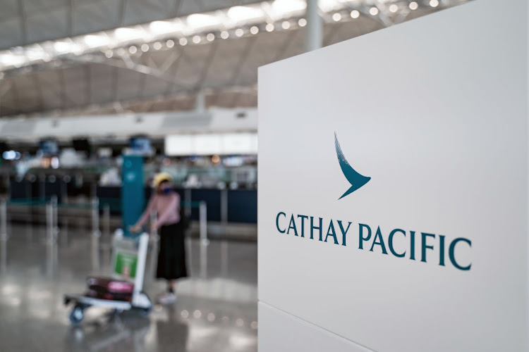 Signage of Cathay Pacific is displayed near a check-in counter at the Hong Kong International Airport on October 21 202. File picture: GETTY IMAGES/ANTHONY KWAN